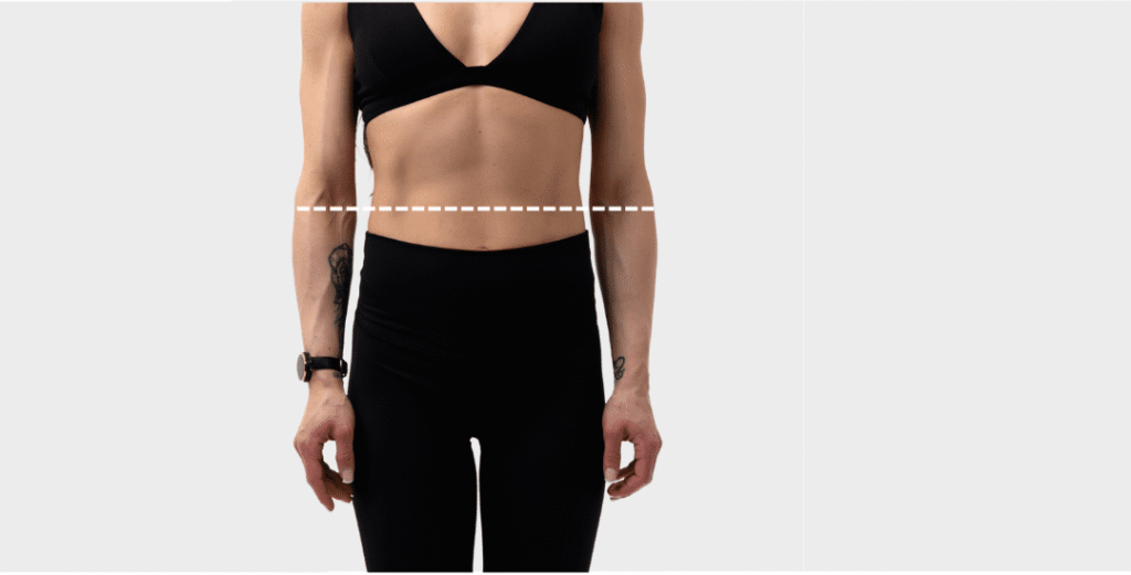 Woman measuring waist circumference with measuring tape at widest point for petite leggings size chart
